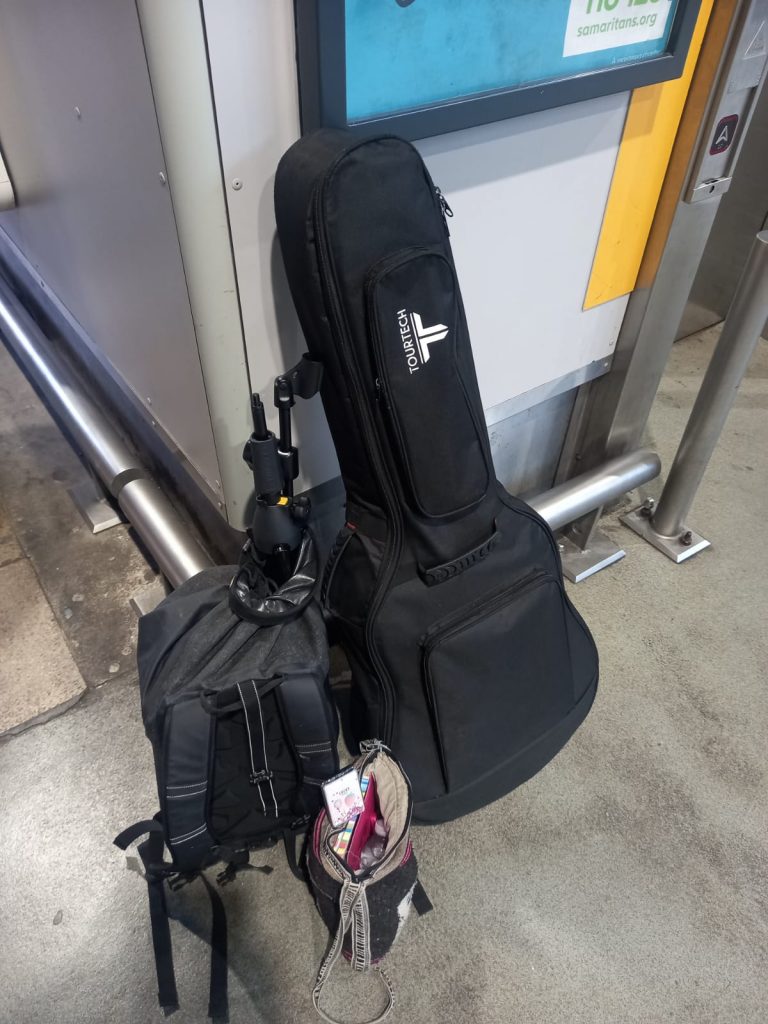 A guitar and two bags at Leeds train station
