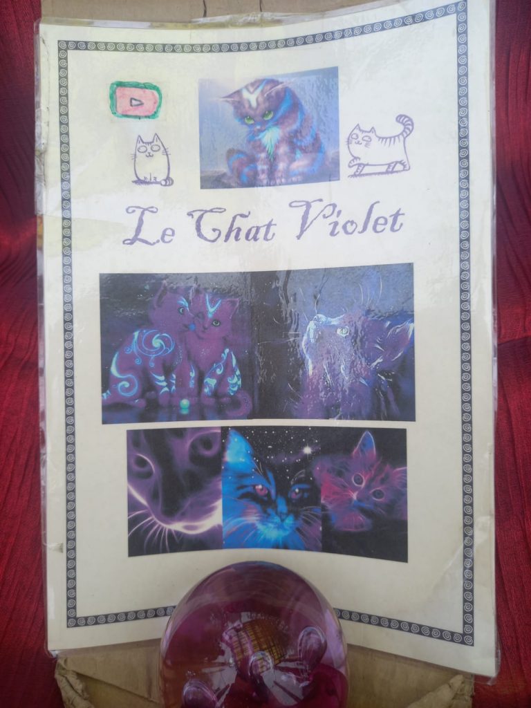 A picture of cats on a poster for Le Chat Violet