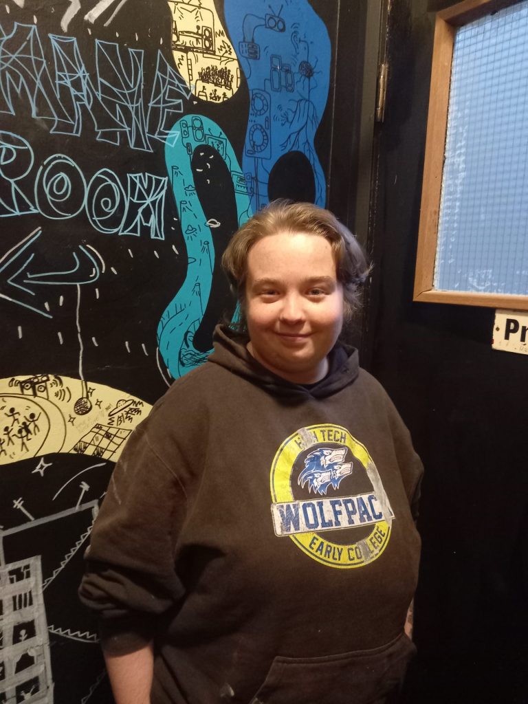 An image of Jack standing in front of a door.