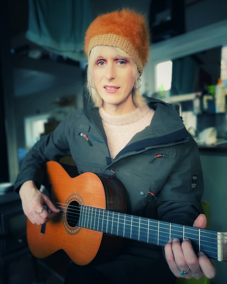 Riana McGovern holding a classic guitar.