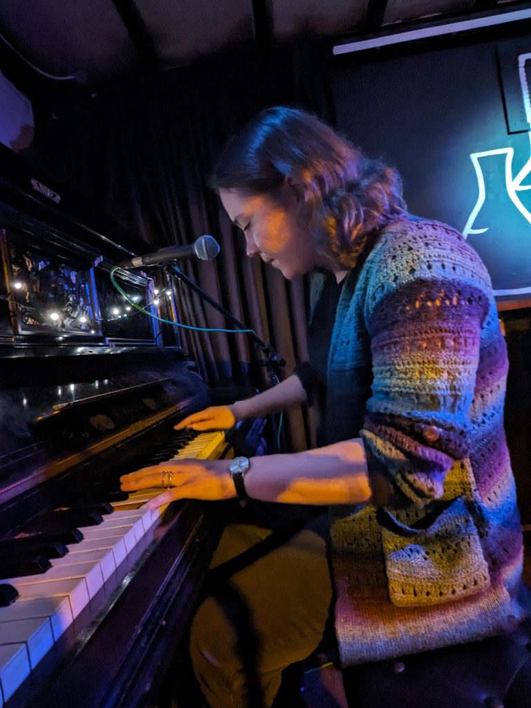 Valerie playing the piano at the Chemic Tavern